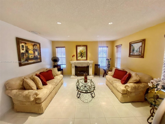 living room featuring light tile patterned floors and a textured ceiling