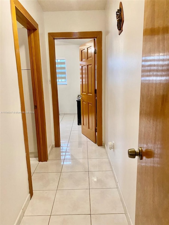 corridor featuring light tile patterned floors