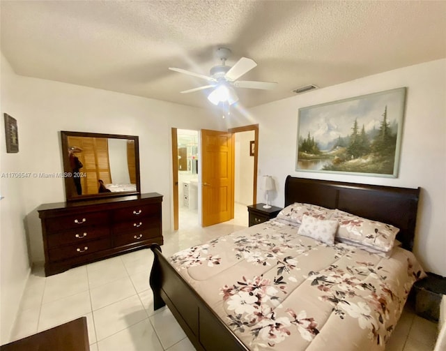 bedroom featuring a textured ceiling, ensuite bathroom, ceiling fan, and light tile patterned flooring