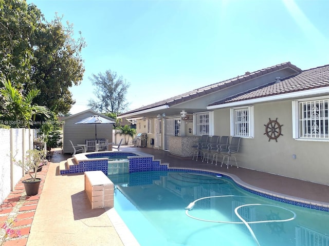 view of pool featuring an in ground hot tub, grilling area, exterior bar, and a patio area