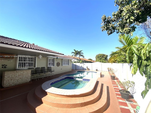 view of swimming pool featuring an in ground hot tub and a patio area