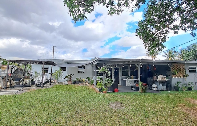 back of house featuring a lawn and a patio