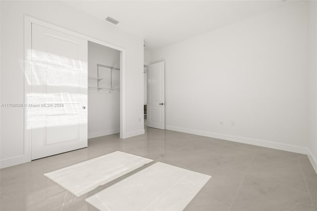 unfurnished bedroom featuring a closet and light tile patterned flooring