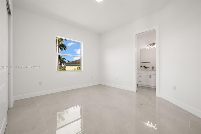 unfurnished bedroom featuring connected bathroom