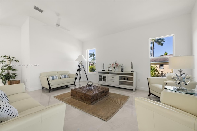 living room with a wealth of natural light and ceiling fan