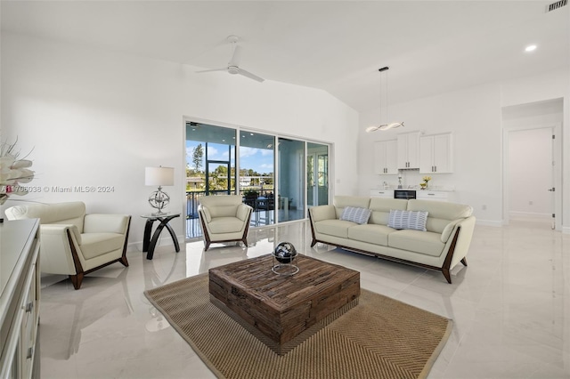 living room featuring ceiling fan and lofted ceiling