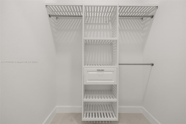 spacious closet featuring light tile patterned floors