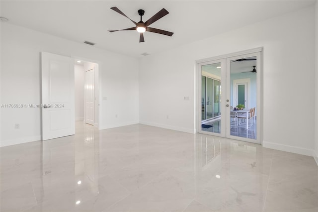 unfurnished room with ceiling fan and french doors