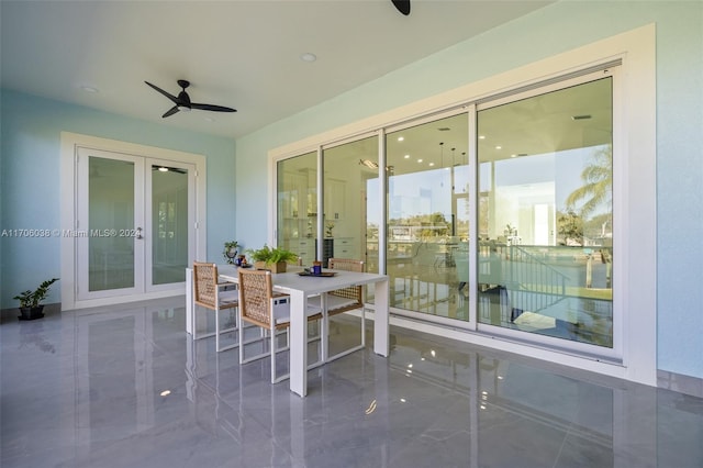 sunroom featuring ceiling fan and french doors