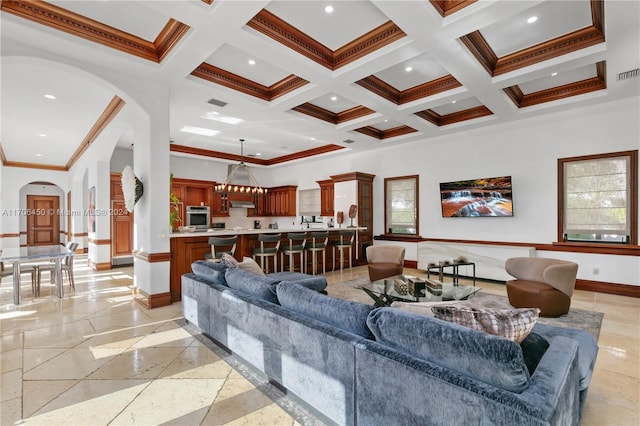 living room featuring beamed ceiling, crown molding, and coffered ceiling