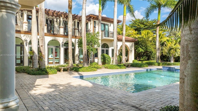 view of swimming pool featuring a patio area and pool water feature