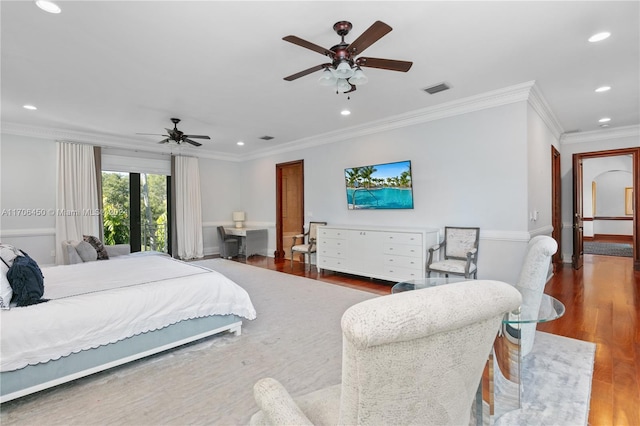 bedroom with ornamental molding, ceiling fan, and dark wood-type flooring