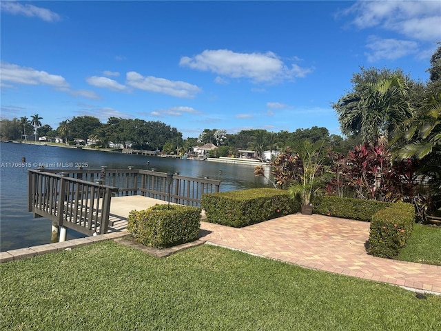 view of dock featuring a water view and a lawn