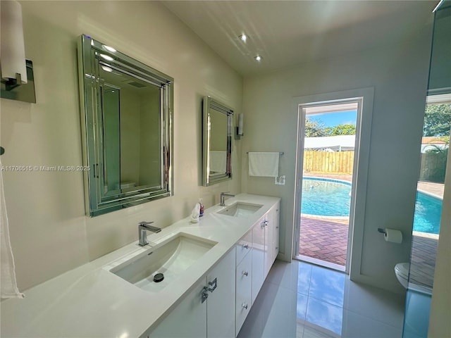 bathroom with tile patterned flooring, vanity, and toilet