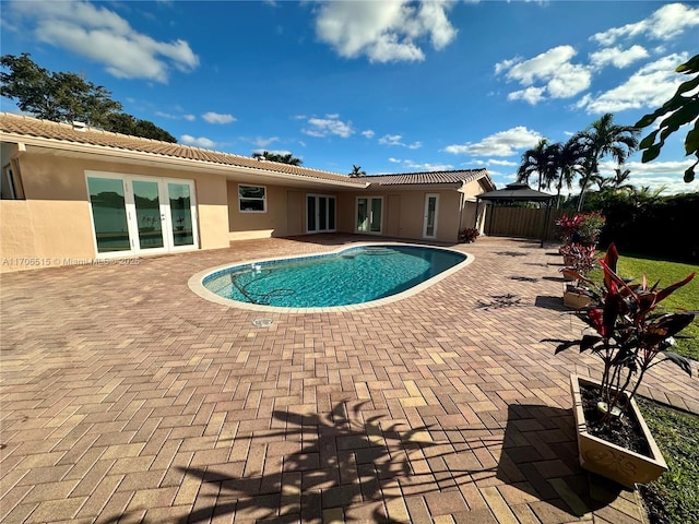 view of pool featuring french doors and a patio