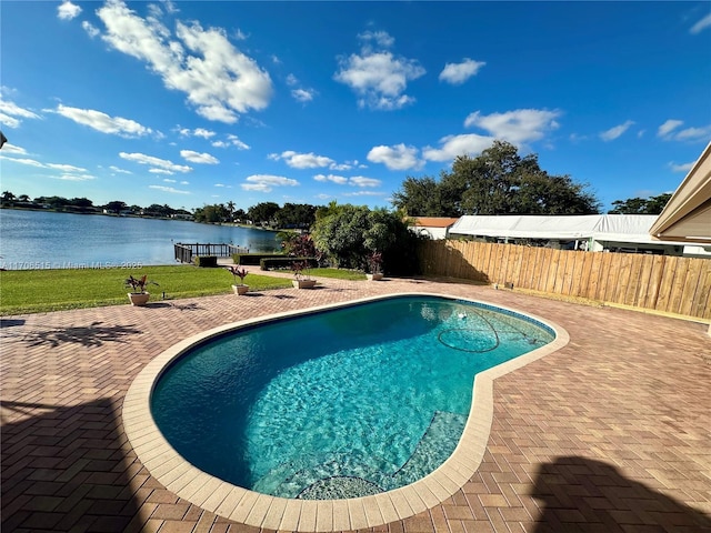 view of swimming pool with a patio area and a water view