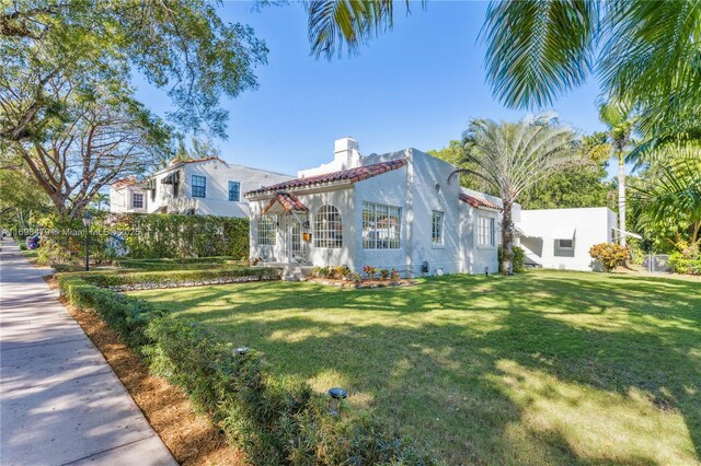 mediterranean / spanish-style home with a front yard