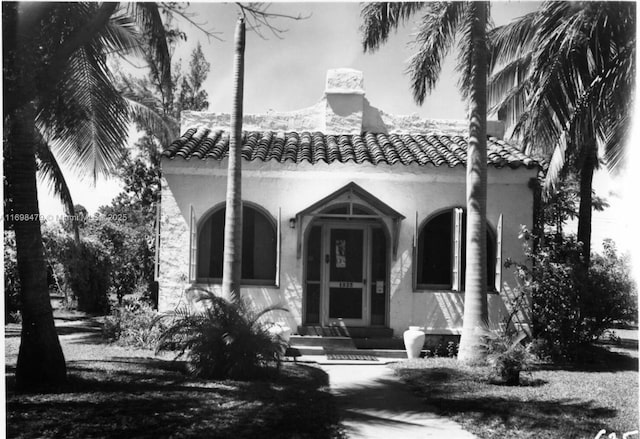 mediterranean / spanish-style home with a tile roof and stucco siding