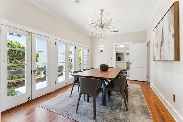 dining area featuring ornamental molding, french doors, and wood finished floors