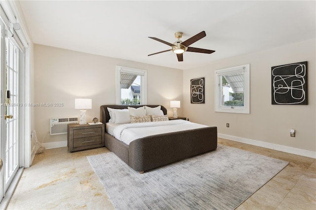 bedroom with multiple windows, baseboards, a ceiling fan, and a wall mounted AC