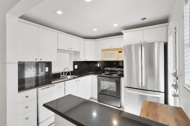 421 NE 14th Ave Unit 203, Hallandale Beach, FL 33009 - kitchen featuring white appliances, dark countertops, white cabinetry, recessed lighting, and backsplash