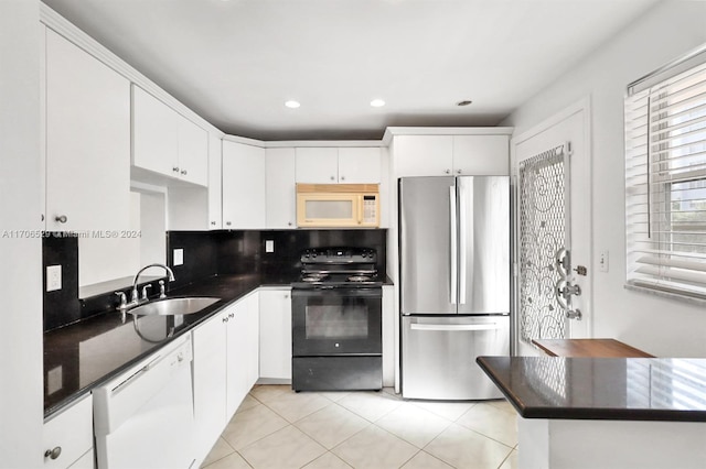 421 NE 14th Ave Unit 203, Hallandale Beach, FL 33009 - kitchen with white appliances, dark countertops, white cabinetry, light tile patterned floors, and recessed lighting
