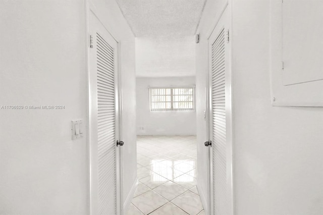 421 NE 14th Ave Unit 203, Hallandale Beach, FL 33009 - hallway featuring light tile patterned floors and a textured ceiling