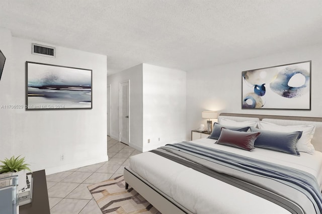 tiled bedroom with a textured ceiling