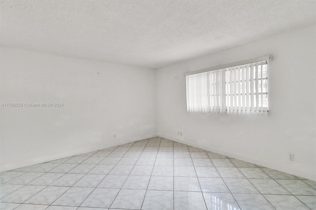 421 NE 14th Ave Unit 203, Hallandale Beach, FL 33009 - spare room featuring a textured ceiling