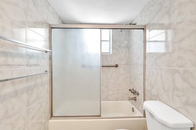 421 NE 14th Ave Unit 203, Hallandale Beach, FL 33009 - full bath featuring bath / shower combo with glass door and tile walls
