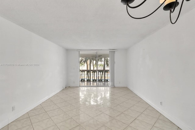 421 NE 14th Ave Unit 203, Hallandale Beach, FL 33009 - empty room with light tile patterned flooring and a chandelier