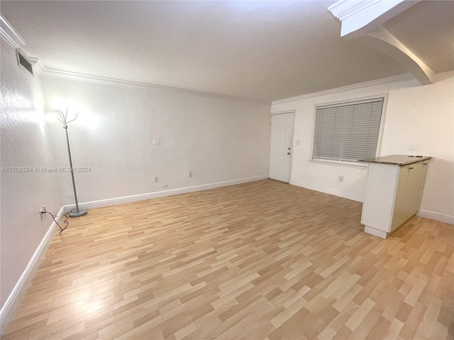 spare room with light hardwood / wood-style flooring and ornamental molding