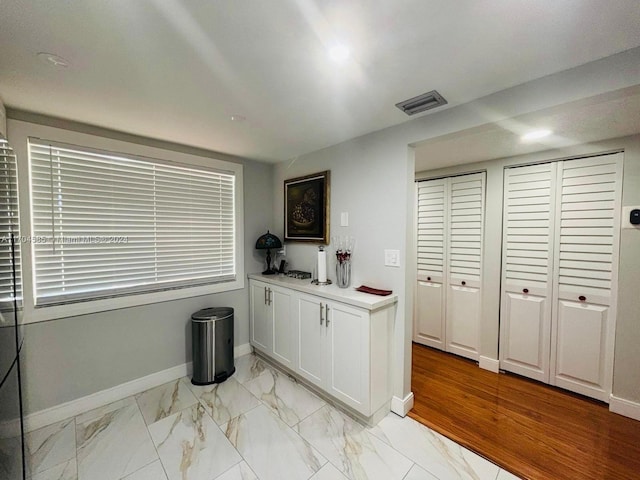 kitchen featuring white cabinets and light wood-type flooring