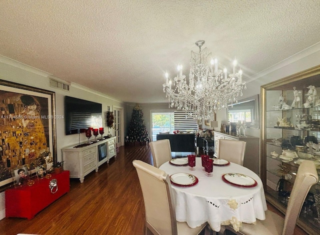 dining area featuring a textured ceiling, an inviting chandelier, crown molding, and dark wood-type flooring