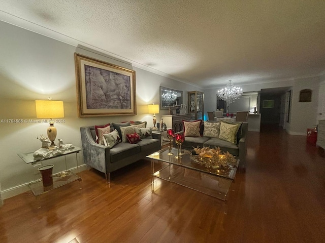 living room featuring a notable chandelier, ornamental molding, a textured ceiling, and hardwood / wood-style flooring