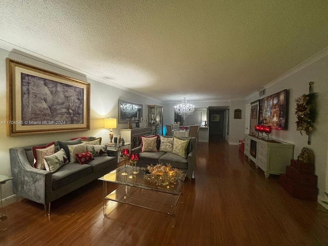 living room with crown molding, dark hardwood / wood-style flooring, a textured ceiling, and a chandelier