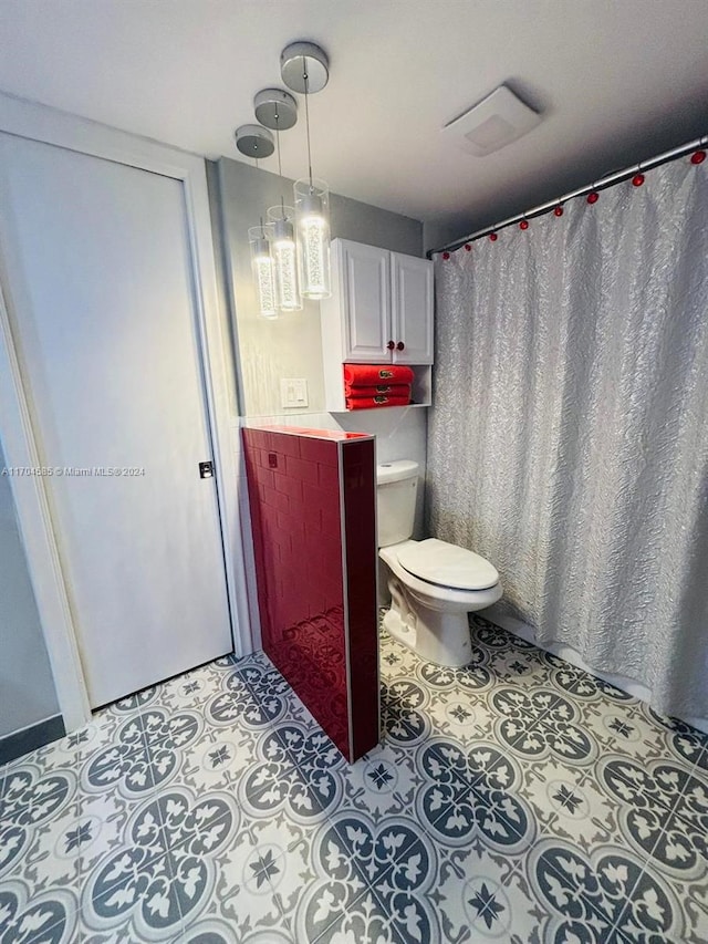 bathroom with toilet and curtained shower