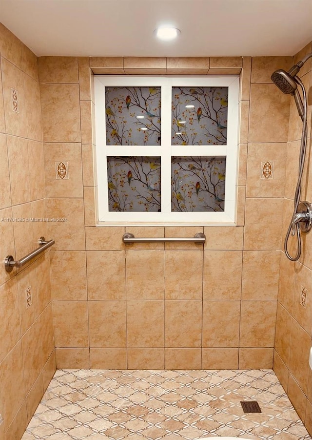 bathroom with a tile shower