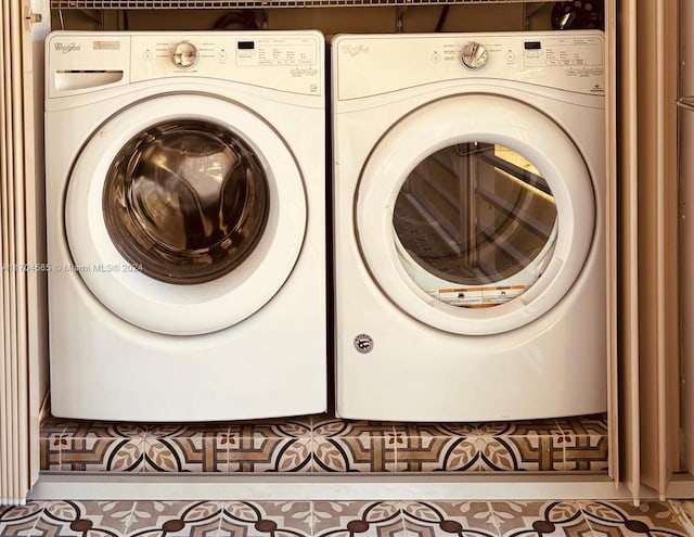 laundry room with tile patterned floors and washer and dryer