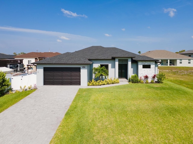 prairie-style home featuring a garage and a front yard