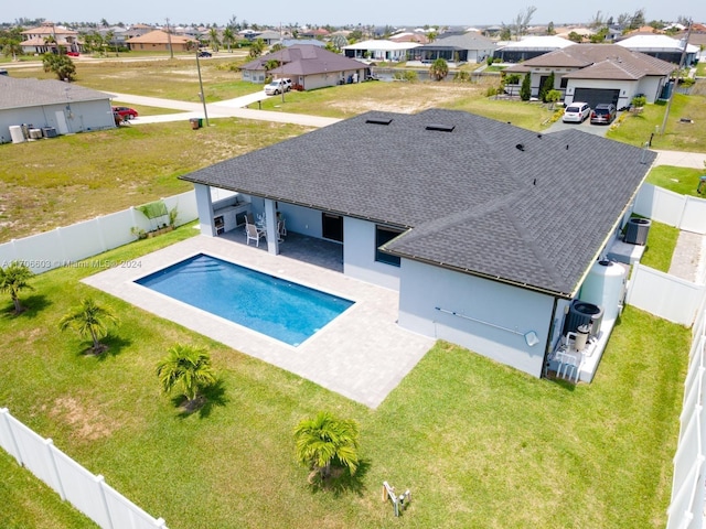 view of swimming pool featuring central air condition unit and a patio