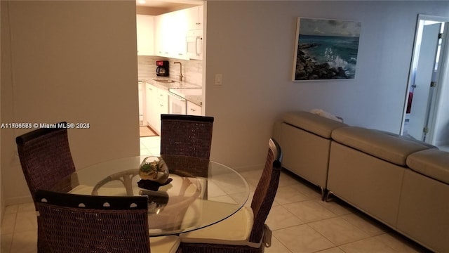 dining space with sink and light tile patterned floors