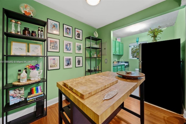 kitchen with black refrigerator and light wood-type flooring