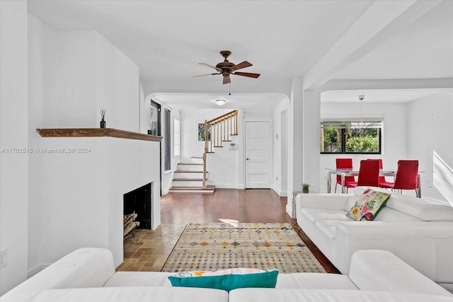 living room with ceiling fan and dark hardwood / wood-style flooring