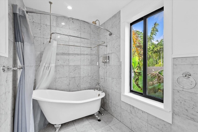 bathroom with tile walls and independent shower and bath