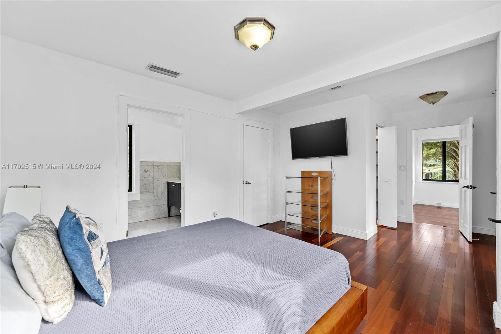 bedroom featuring wood-type flooring and connected bathroom