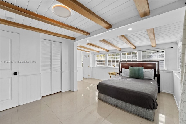 tiled bedroom with beamed ceiling and wooden ceiling