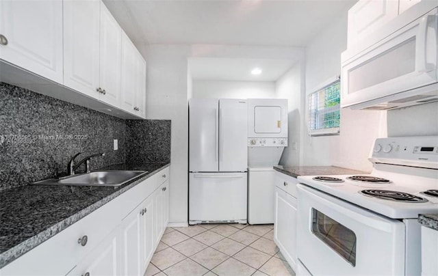 kitchen featuring light tile patterned floors, white cabinetry, backsplash, white appliances, and sink