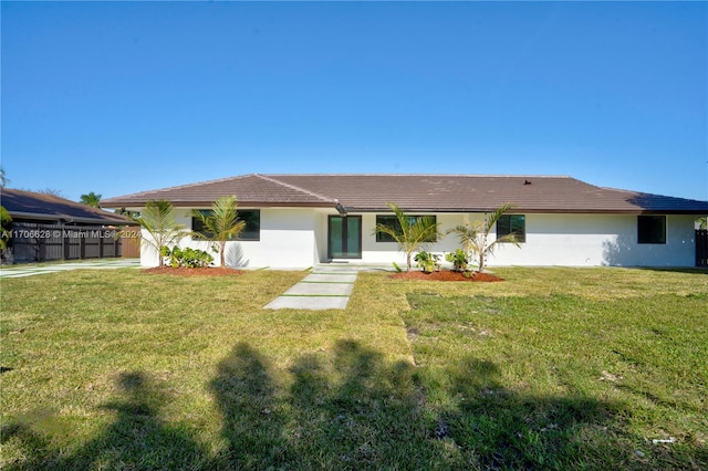 rear view of house with a lawn