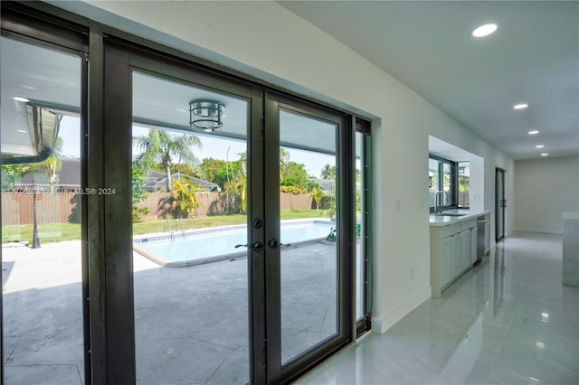 entryway featuring french doors, a wealth of natural light, and sink